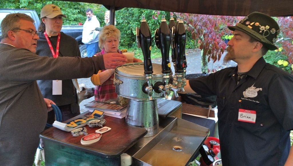Brian Anderson of Morgantown Brewing Company serves up a sample at Bramwell Oktoberfest.