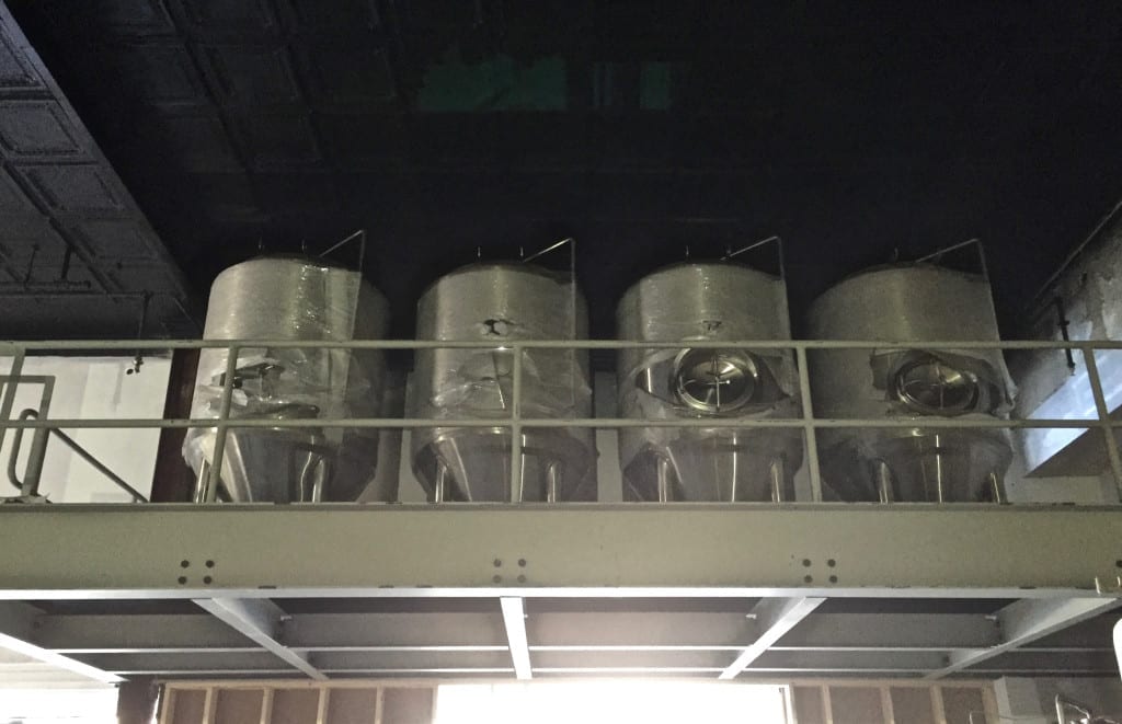 Fermentation tanks located on a mezzanine level.