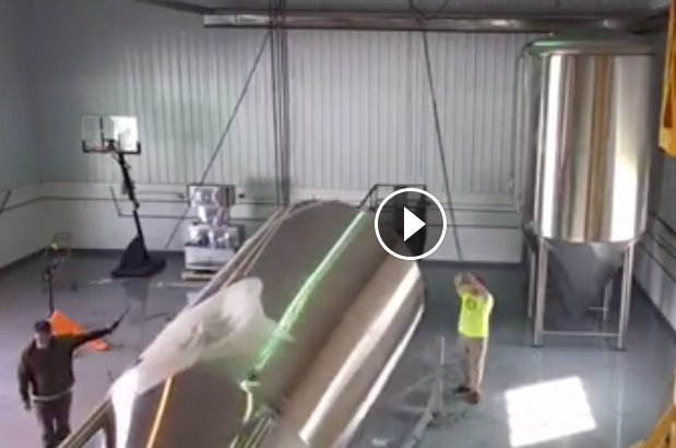 Installing large stainless steel fermenters at Morgantown Brewing Company's new production brewery in Westover. 