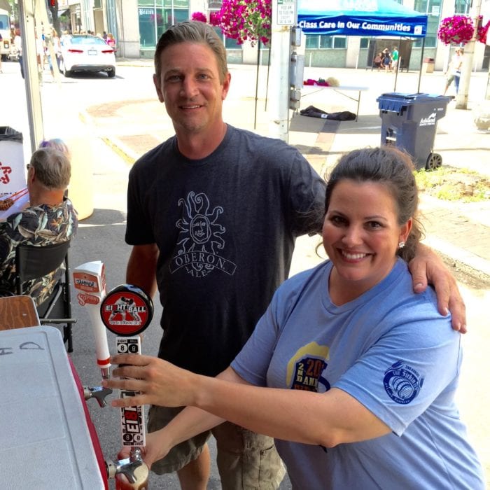 Matt Curreri of Beer house with a volunteer pourer dispensing a sample of Ei8gh Ball's red ale.